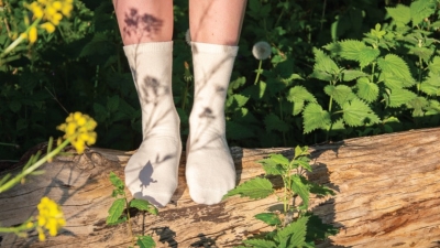 Sustainable socks with a QR Code powered by GS1 label on natural wood, showcasing sustainability