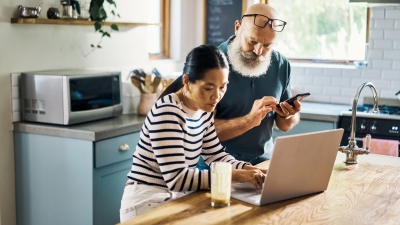 couple using phone and computer